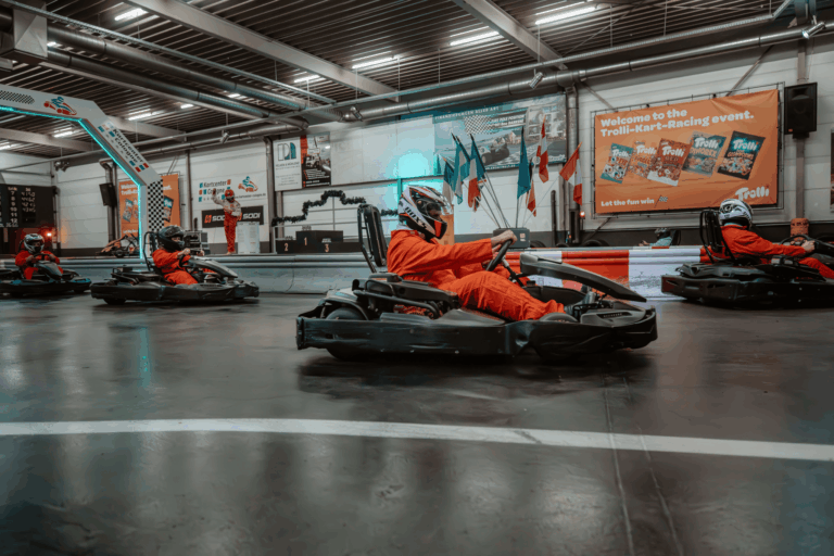 Mehrere Karts fahren mit Abstand auf der Geraden im Wettkampf beim Kartcenter Cologne, Kartfahren Köln.